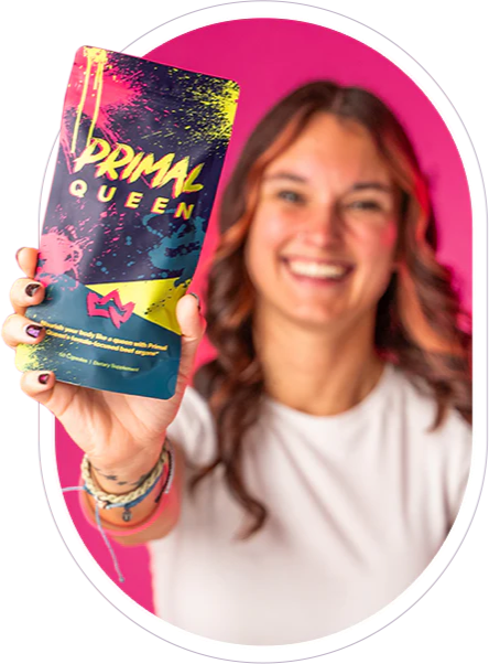 Smiling woman holding colorful Primal Queen product package against a pink background.
