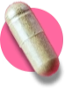 A single capsule against a pink background.