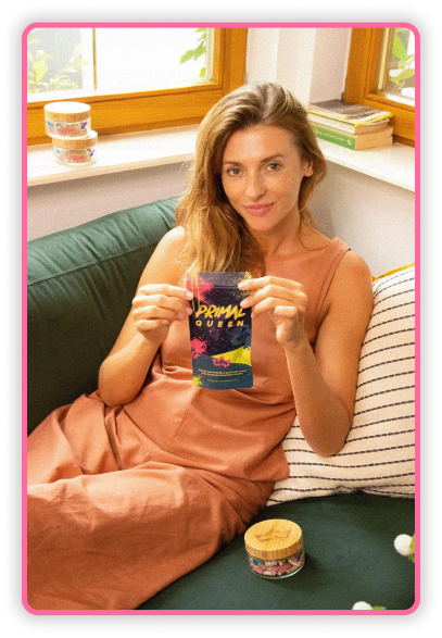 Woman sitting on sofa, holding a package labeled 'Primal Queen'.