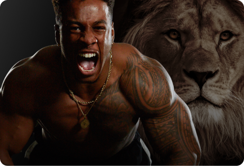 A man with tattoos roars, while a lion looks on in the background.