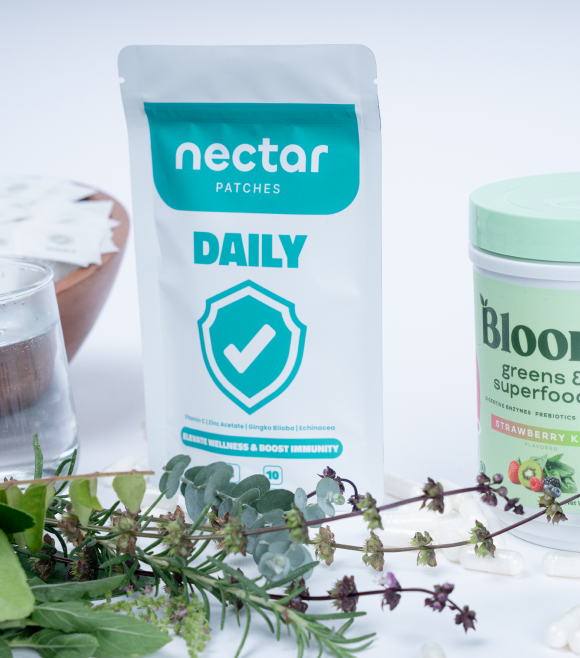 Nectar patches and Bloom superfoods with fresh herbs and a glass of water.