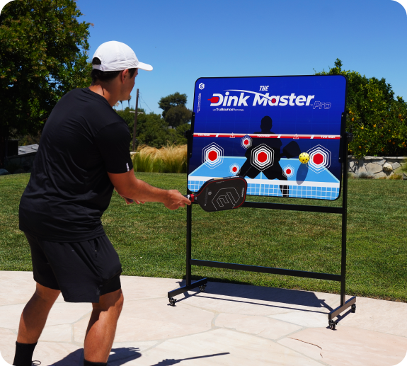 Person practicing pickleball with a target board in an outdoor setting.