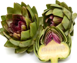 Three fresh whole artichokes, one cut in half, showing the interior.