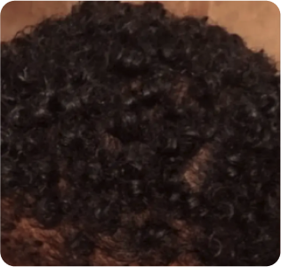 Close-up of curly black hair.