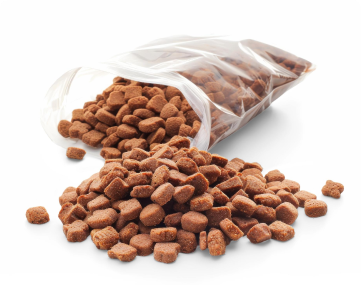 A bag of dry pet food spilled on a white surface.