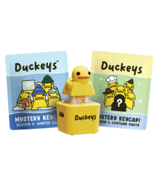 Duckeys keycap with yellow duck figure, displayed with colorful packaging cards.