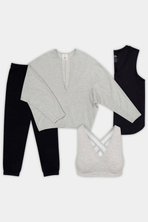 Casual clothing set including a grey top and sports bra, black pants, and a sleeveless shirt.