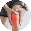Person holding their painful, red, swollen knee.