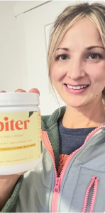 Person holding a container of dietary supplement, smiling at the camera.