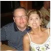 A smiling couple sitting together at a table in a casual setting.