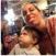 A woman and child smiling together indoors.
