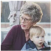 An elderly woman holding a young child.