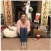 Person sitting on the floor in a living room with festive decorations and gifts around.