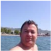 A person at the beach with mountains in the background.