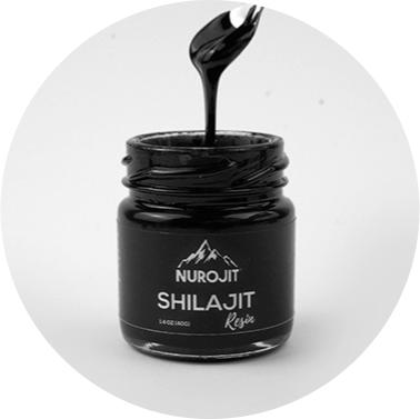 A jar of Nurojit Shilajit resin with a spoon above it.