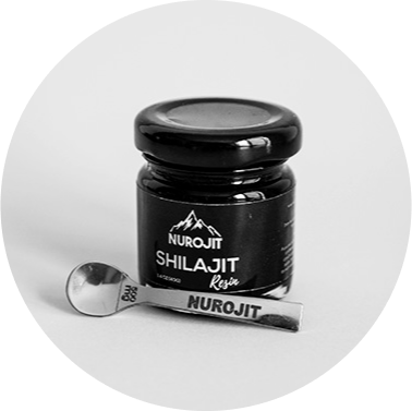 Nurojit Shilajit resin jar with a small metal spoon beside it.