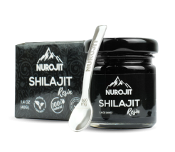 A jar of Nurojit Shilajit resin with a small spoon next to it.