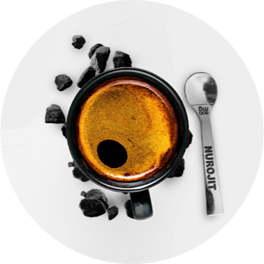 A cup of black coffee with a spoon on a white background.