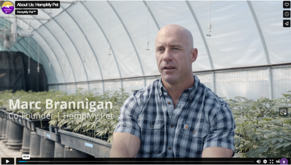 Marc Brannigan, Co-Founder of HempMy Pet, in a greenhouse being interviewed.
