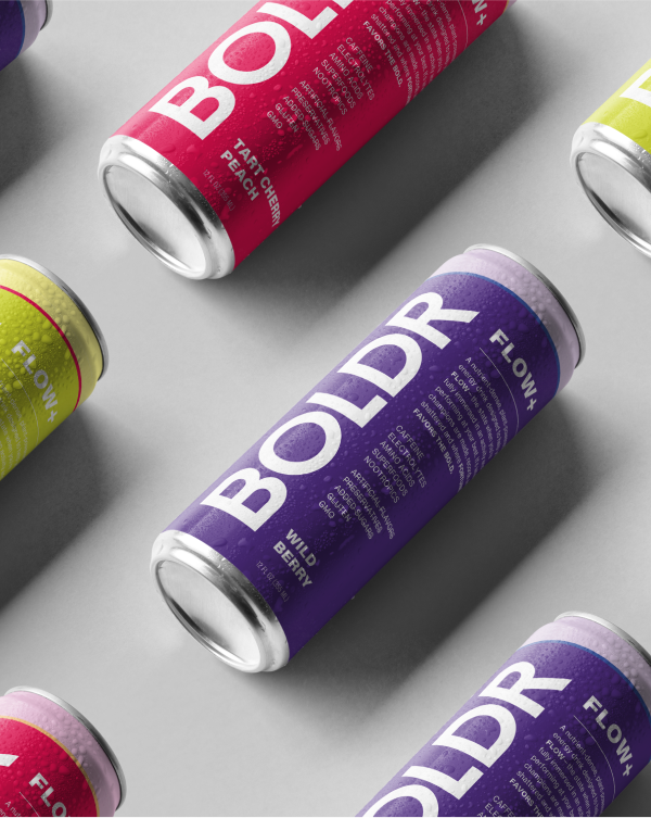 Colorful cans of BOLDR Flow+ energy drink on a light background.