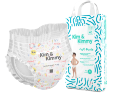 Disposable baby diaper next to its packaging labeled 'Kim & Kimmy Oops Pants.'