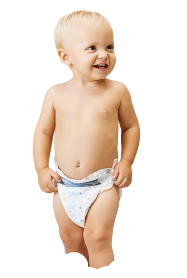 A smiling toddler in a diaper standing and looking to the side.