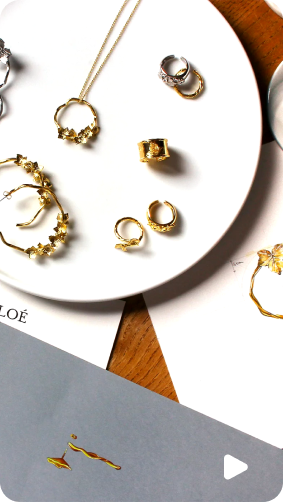 Various gold and silver jewelry pieces displayed on a white plate.