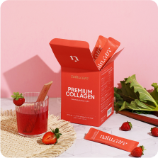 Collagen supplement box with strawberry sticks, a glass, and fresh strawberries on a table.